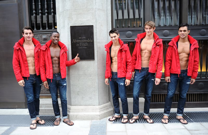 MUNICH, GERMANY - OCTOBER 25: Male models pose outside the Abercrombie & Fitch flagship clothing store before the opening of Abercrombie & Fitch Munich flagship store on October 25, 2012 in Munich, Germany. (Photo by Hannes Magerstaedt/Getty Images)
