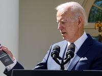 President Joe Biden holds U.S. Senator Rick Scott's (R-FL) \"12-point plan to Rescue America,\" as he speaks at an event on health care costs, Medicare and Social Security, in the Rose Garden at the White House.