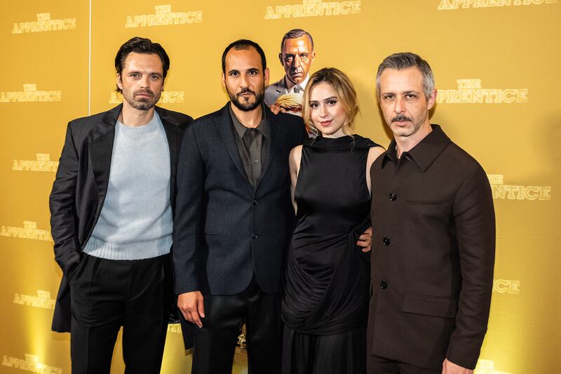 US-Romanian actor Sebastian Stan, Iranian director Ali Abbasi, Bulgarian actress Maria Bakalova and US actor Jeremy Strong pose for a photo as they arrive for the gala premiere of the movie The Apprentice at the Imperial in Copenhagen, Denmark, on October 16, 2024. The explosive Donald Trump biopic "The Apprentice" premiered in Denmark after it hit US theaters, with filmmakers gambling that it will draw audiences in a fiercely polarized nation just weeks before its subject's election showdown with rival Kamala Harris. The hot-topic film about the Republican candidate's younger years has drawn legal threats from Trump's attorneys, not least for deeply unflattering scenes including a depiction of the former president raping his wife. (Photo by Emil Nicolai Helms / Ritzau Scanpix / AFP) / Denmark OUT (Photo by EMIL NICOLAI HELMS/Ritzau Scanpix/AFP via Getty Images)