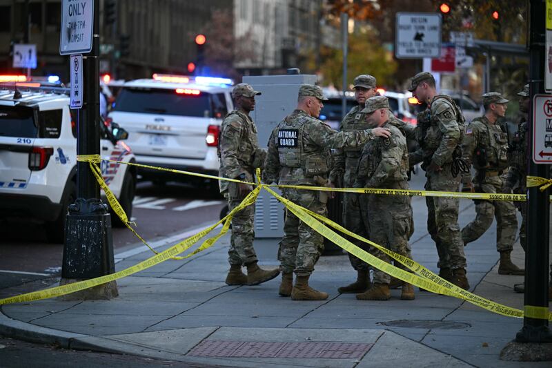 National Guard soldiers gather near a crime scene after a shooting in downtown Washington, DC, on November 26, 2025.