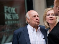 Fox News chairman Roger Ailes walks with his wife as they leave the News Corp building in New York City.