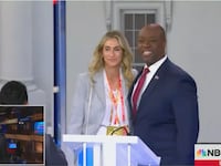 Tim Scott smiles with a mystery woman after Wednesday’s third GOP debate.