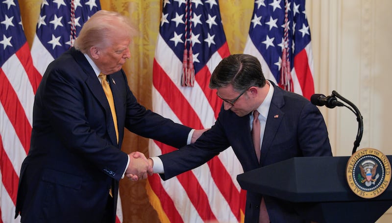 WASHINGTON, DC - JULY 22: U.S. President Donald Trump and House Speaker Mike Johnson shake hands at a reception for Republican members of the House of Representatives in the East Room of the White House on July 22, 2025 in Washington, DC. Trump thanked GOP lawmakers for passing the One Big Beautiful Bill Act. (Photo by Chip Somodevilla/Getty Images)