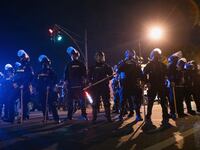 Louisville police block an intersection during a curfew amid protests.