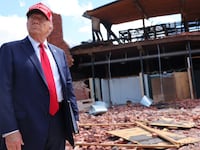 Republican presidential nominee, former U.S. President Donald Trump, listens to a question as he visits Chez What Furniture Store which was damaged during Hurricane Helene on September 30, 2024 in Valdosta, Georgia.