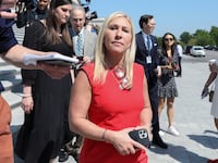 U.S. Rep. Marjorie Taylor Greene walks through reporters on Capitol Hill.