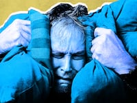 man colored in blue is in angst and holding two pillows by each ear