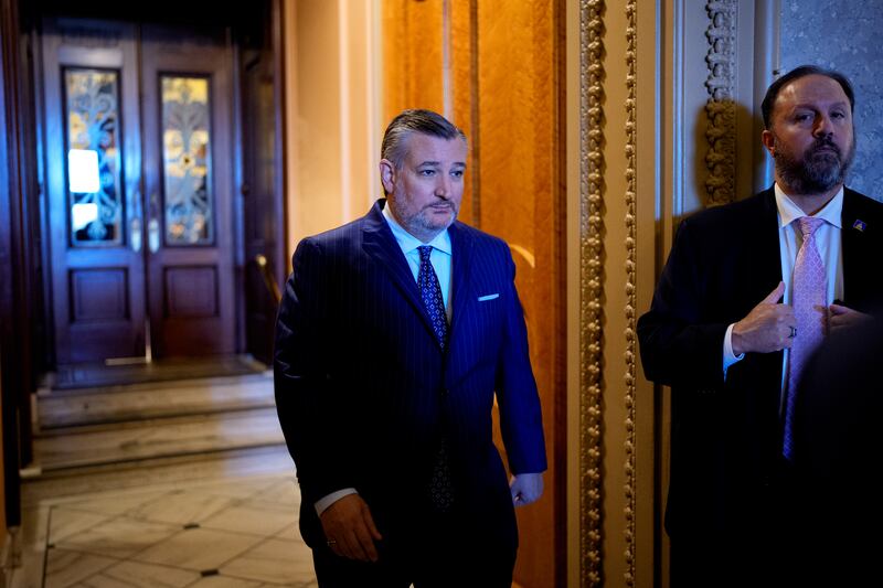 Sen. Ted Cruz walks out of the Senate chamber on the first day of the government shutdown.
