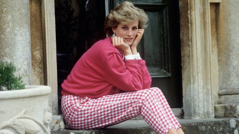 Princess Diana sitting on a front step at her house in 1986.
