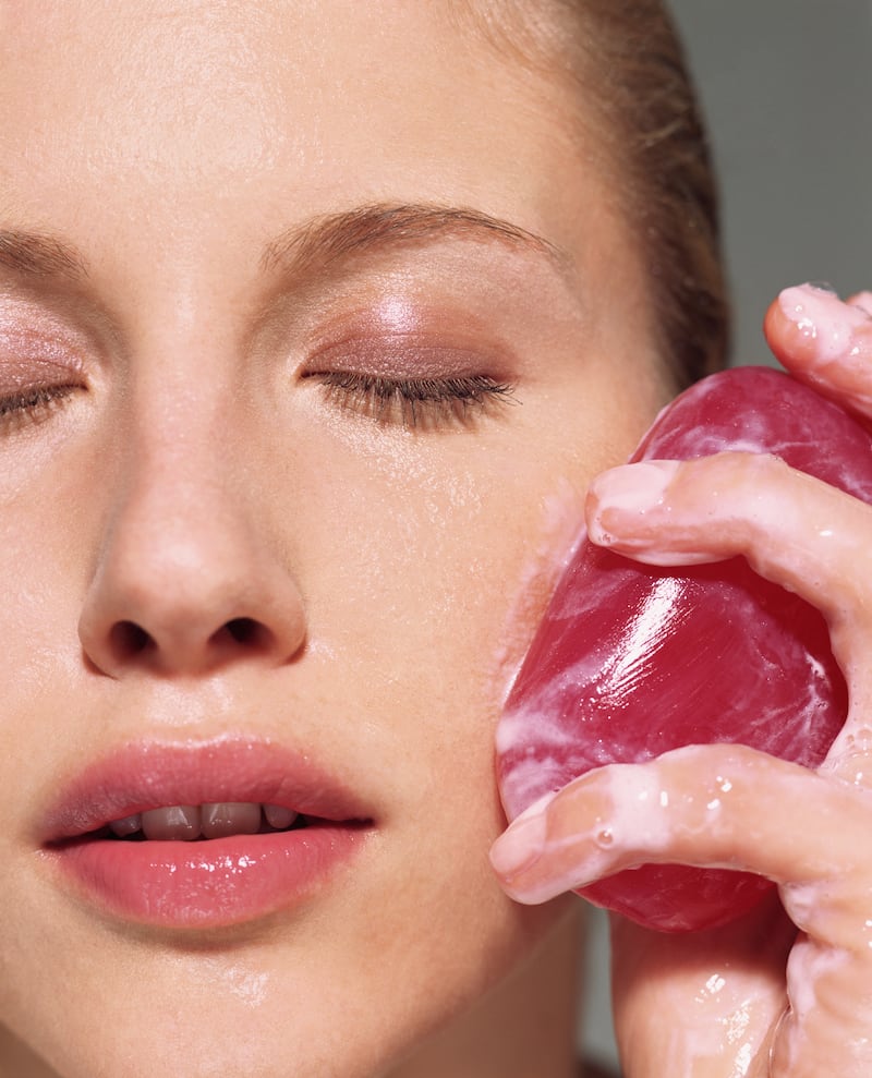 A woman cleansing her skin