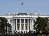 An American flag flies over the south facade of the White House in Washington, D.C.