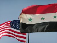 Iraqi and U.S. flags fly over al-Asad air base August 29, 2005 in Al Asad, Iraq.