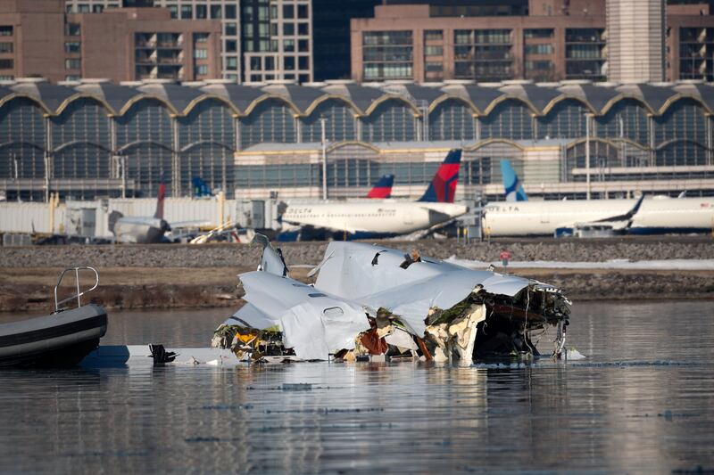 In this U.S. Coast Guard handout, the Coast Guard investigates aircraft wreckage on the Potomac River on January 30, 2025 in Washington, DC. An American Airlines flight from Wichita, Kansas collided midair with a military Black Hawk helicopter while on approach to Ronald Reagan Washington National Airport outside of Washington, DC. According to reports, there were no survivors among the 67 people onboard both aircraft.