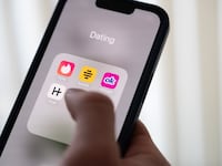 24 October 2024, Lower Saxony, Hanover: ILLUSTRATION - A woman holds a smartphone on which the dating apps Tinder, Bumble, OkCupid and Hinge are displayed.