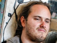 David Depape, with long hair and a beard, stares forward in a 2013 photo.