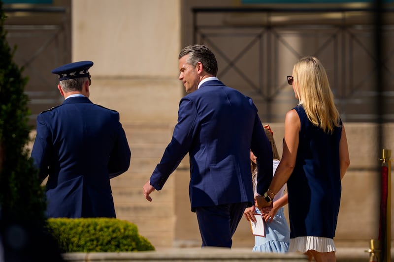 ARLINGTON, VIRGINIA - SEPTEMBER 18: U.S. Secretary of War Pete Hegseth (C), his wife Jennifer Hegseth (R), and Chairman of the Joint Chiefs of Staff Air Force Gen. Dan Caine (L), depart following the Department of War's 2026 National POW/MIA Recognition Day Ceremony on the Pentagon River Terrace Parade Field on September 18, 2026 in Arlington, Virginia. The ceremony honored American service members who were held as prisoners of war and later returned home, as well as those still listed as missing in action from past conflicts. (Photo by Andrew Harnik/Getty Images)