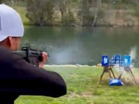 Kid Rock shoots up a case of Bud Light beer.