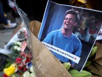 A memorial with flowers and a photo of the late actor Matthew Perry.