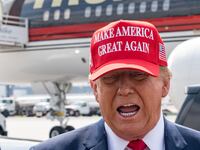 Former U.S. President Donald Trump speaks to the media as he arrives at the Atlanta Airport.