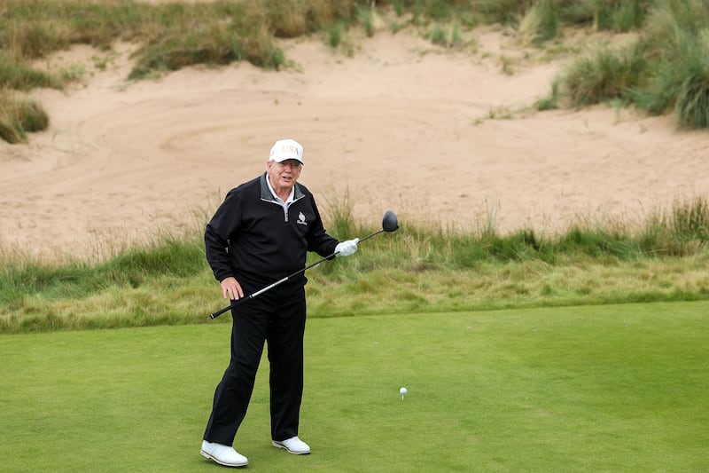 U.S. President Donald Trump tees off after opening his new golf course at his Trump International Golf links resort