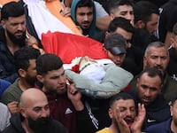 Mourners carry the body of Jihad Abu Alia, who was killed in clashes with Israeli settlers in the village of Mughayir, on April 13, 2024.