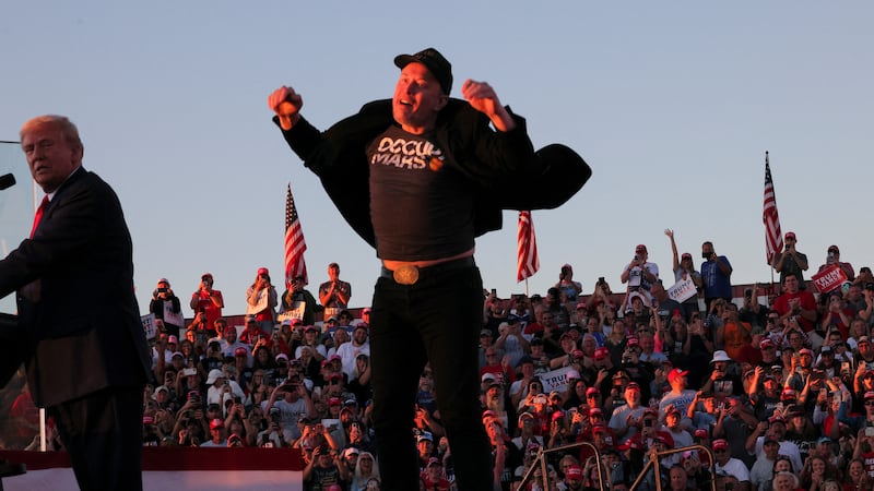 Tesla CEO and X owner Elon Musk jumps on the rally stage.