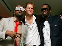 Kanye West (L) poses with Prince Harry (C) and US rapper P Diddy (R) at Wembley Arena in north London, 01 July 2007