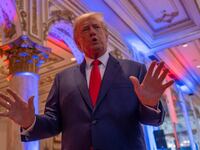 Donald Trump has his hands up while speaking inside Mar-a-Lago.