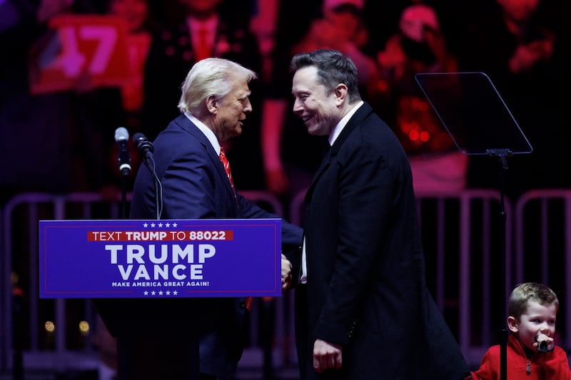 Elon Musk walks on stage with his son, X, beside President-elect Donald Trump during a rally at Capital One Arena in Washington, on January 19, 2025.