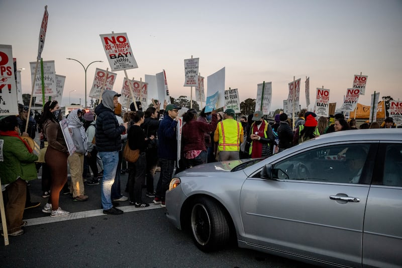 Protesters block a road to Coast Guard Island Alameda during a protest where federal law enforcement agents