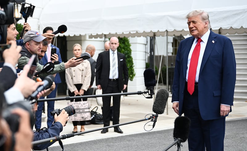 White House Press Secretary Karoline Leavitt and White House Deputy Chief of Staff for Policy and Homeland Security Advisor Stephen Miller watch US President Donald Trump speak to journalists as he makes his way to board Marine One before departing from the South Lawn of the White House in Washington, DC on June 15, 2025. Trump is headed to Canada to attend the G7 summit. (Photo by Mandel NGAN / AFP) (Photo by MANDEL NGAN/AFP via Getty Images)