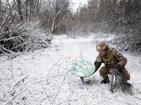 A soldier disconnects their Starlink on the front line at Orthodox Christmas, during a ceasefire announced by Russia over the Orthodox Christmas period, from the frontline region of Kreminna, Ukraine, January 6, 2023.