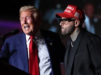 Republican presidential nominee, former U.S. President Donald Trump, (L) appears on stage with recording artist Nicky Jam during a campaign rally at The Expo at World Market Center Las Vegas on September 13, 2024 in Las Vegas, Nevada