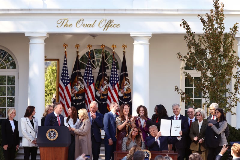 U.S. President Donald Trump holds up an executive order as he is joined by first lady Melania Trump and members of his administration in the Rose Garden of the White House on October 19, 2026 in Washington, DC.