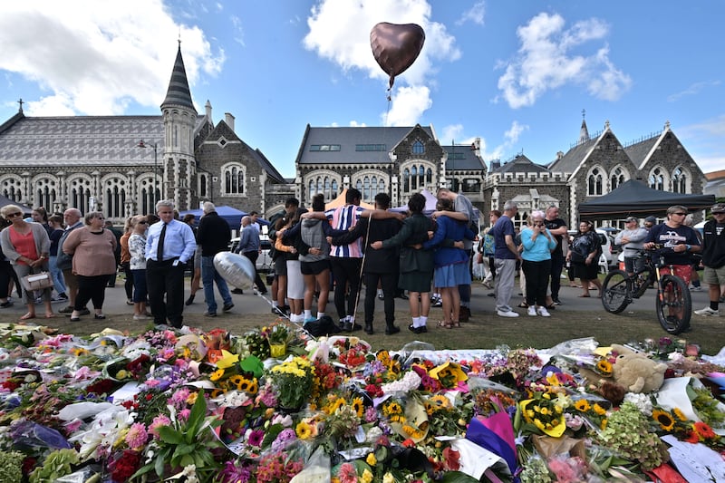 A picture of mourners gathered after Brenton Tarrant’s horrific mass shooting in 2019.