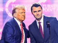 US right-wing activist Charlie Kirk (R) speaks on stage with President Donald Trump at America Fest 2024 in Phoenix, Arizona, on December 22, 2024. Right-wing youth activist and influencer Charlie Kirk, a major ally of President Donald Trump, was shot dead on September 10, 2025 in a murder that sparked fears of more political violence in an increasingly febrile United States. Trump confirmed on social media that Kirk, 31, had died from his injuries. (Photo by JOSH EDELSON / AFP) (Photo by JOSH EDELSON/AFP via Getty Images)