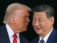 US President Donald Trump (L) talks to China's President Xi Jinping.