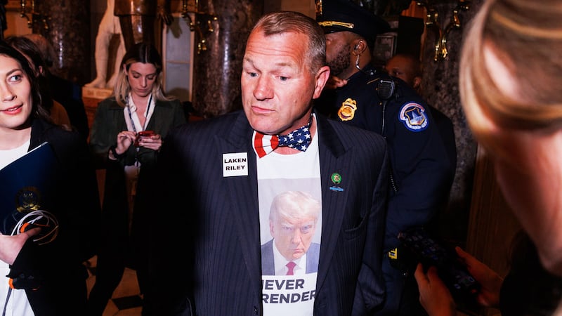 Rep. Troy Nehls walks to the House Chamber wearing a Donald Trump shirt and a Laken Riley pin ahead of the President's State of the Union address