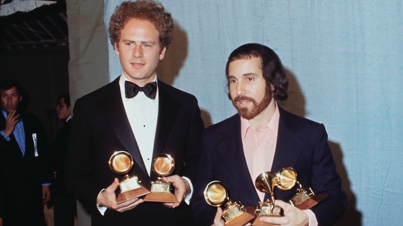 Arthur Garfunkel and Paul Simon hold a Grammy for best record and best album of the year for “Bridge Over Troubled Water” in 1971.