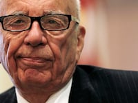 Rupert Murdoch smirks.