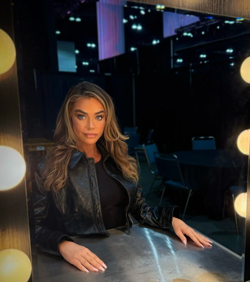 Denise Richards poses in a leather jacket after her viral facelift.