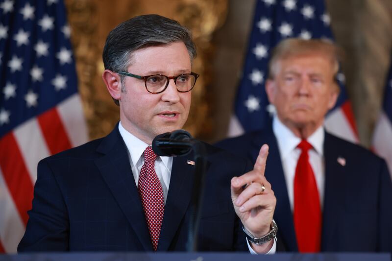 Republican presidential candidate former President Donald Trump listens as Speaker of the House Mike Johnson (R-LA) speaks during a press conference at Mr. Trump's Mar-a-Lago estate on April 12, 2024, in Palm Beach, Florida.