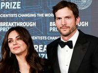 Mila Kunis and Ashton Kutcher pose at the Academy Museum of Motion Pictures in Los Angeles.