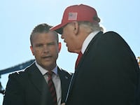 Trump shakes hands with Defense Secretary Pete Hegseth before speaking at Anduril Industries in Sparrows Point, Maryland, on October 6, 2026.
