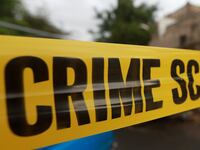 Yellow police tape hangs at a crime scene.