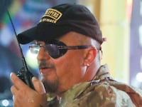 Oath Keepers militia founder Stewart Rhodes uses a radio as he departs with volunteers from a rally held by U.S. President Donald Trump.