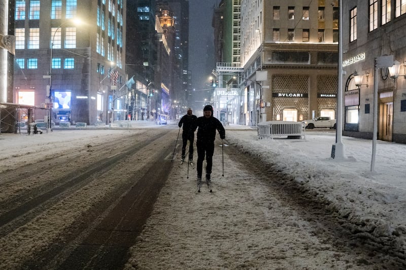 NEW YORK, NEW YORK - FEBRUARY 23: A view of men skiing during a snowstorm in front of a Bergdorf and Goodman Store after midnight as the city braces for a blizzard on Sunday into Monday on February 23, 2026 in New York City. New York City Mayor Zohran Mamdani announced a state of emergency for New York City and issued a travel ban beginning at 9 p.m. tonight, and ending at 12 p.m. on Monday. New York City could get more than a foot of snow with up to two feet on Long Island and in parts of New Jersey. (Photo by Craig T Fruchtman/Getty Images)