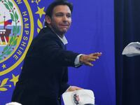 Republican presidential candidate and Florida Gov. Ron DeSantis throws campaign hats into the crowd at a campaign event in Manchester, New Hampshire, June 1, 2023.