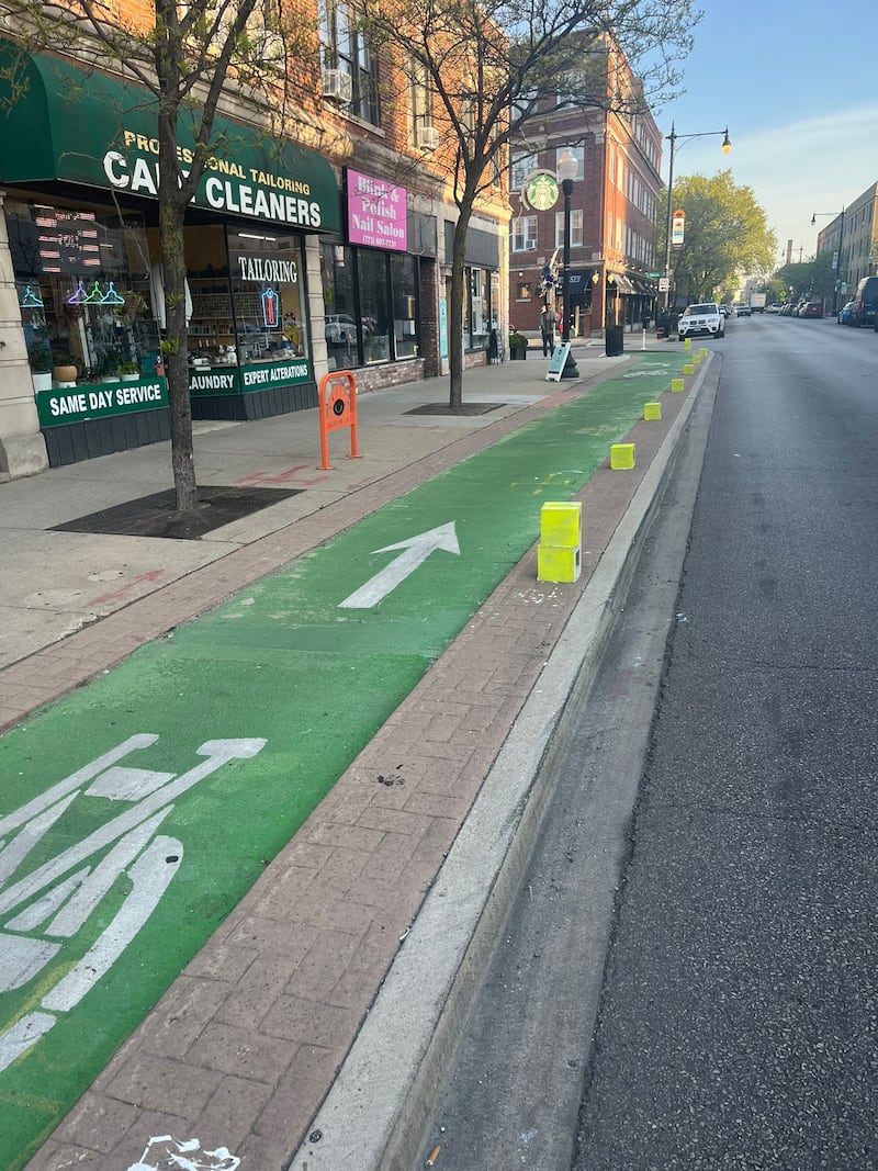 A bootleg bicycle lane barrier created by the People's CDOT out of cinder blocks.
