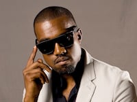 articles/2014/09/14/kanye-west-stops-concert-to-yell-at-wheelchair-bound-kid-stand-up/140620-kanye-obama-cheat_szsbwt